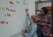 Black Teachers: A Necessary Part of Education Black teacher instructing a student.