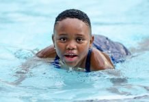 Simplifying Swim Safety: Your Warm Embrace in the Deep End! kid swimming in pool