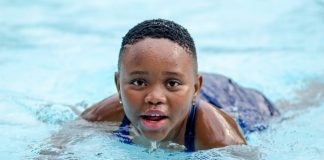 Simplifying Swim Safety: Your Warm Embrace in the Deep End! kid swimming in pool